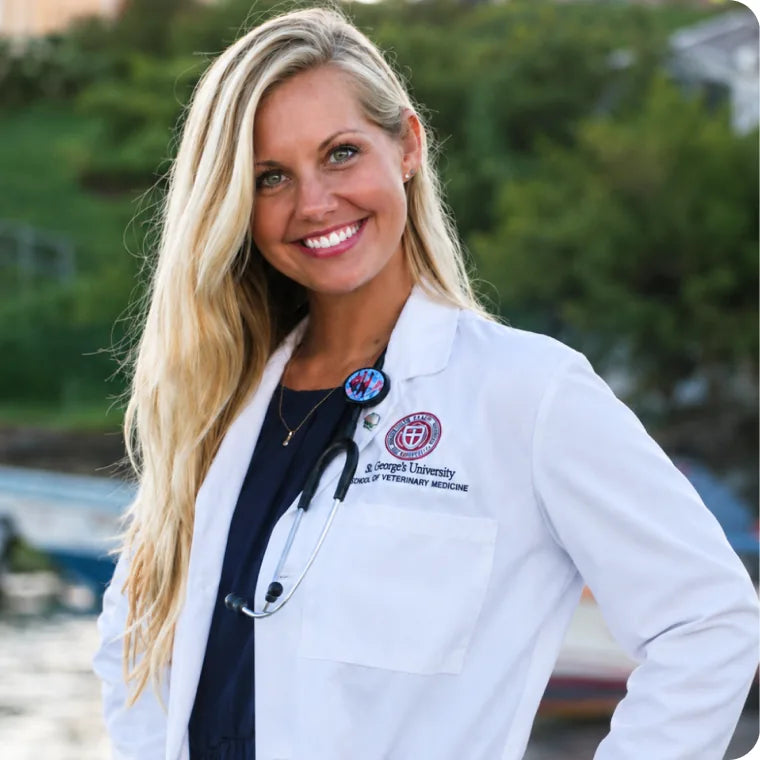 Dr. Lauren Makowski, DVM, smiling in a white veterinary coat